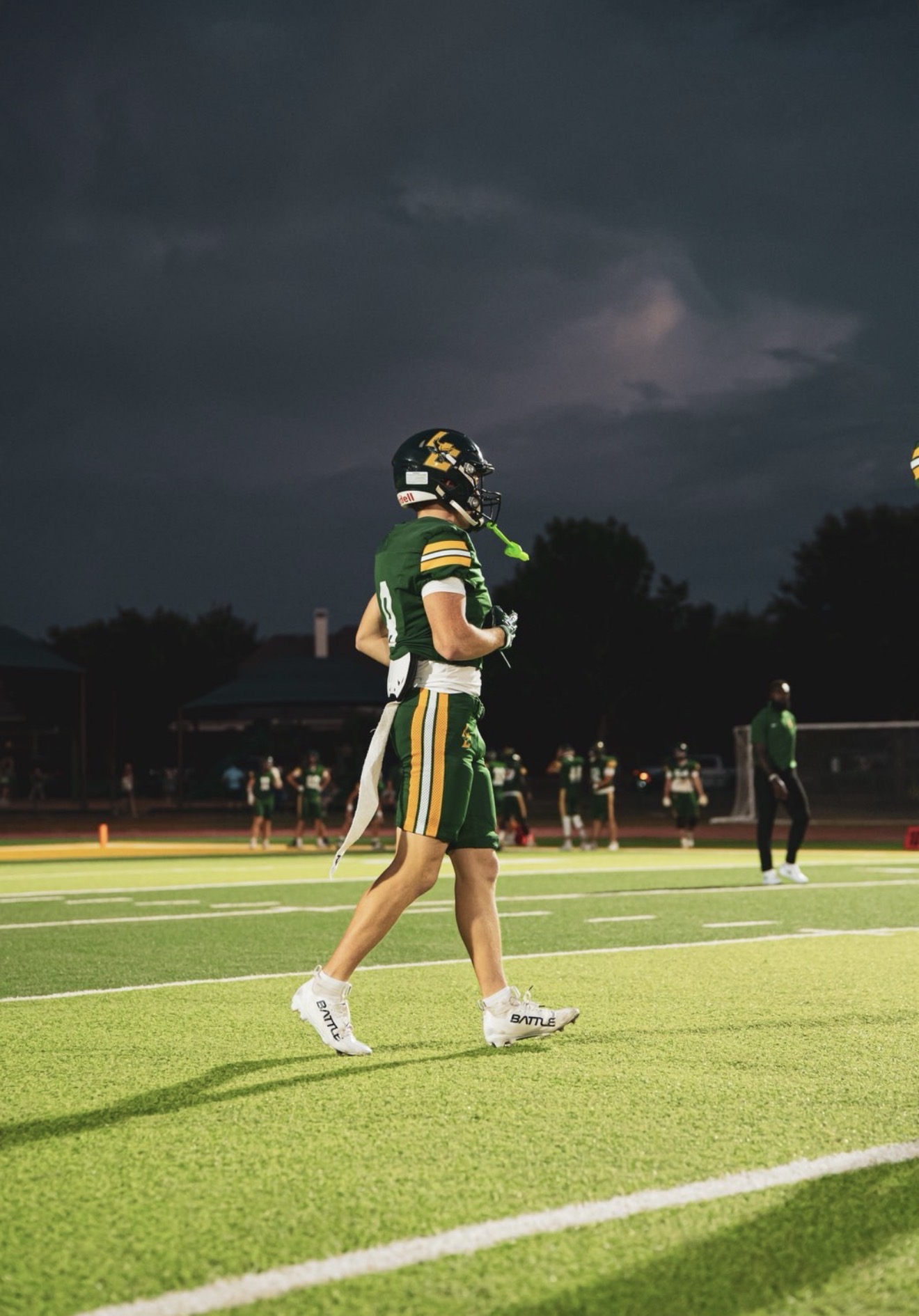 Braden Harbour, wide receiver for Legacy Christian Academy, on the field under stadium lights